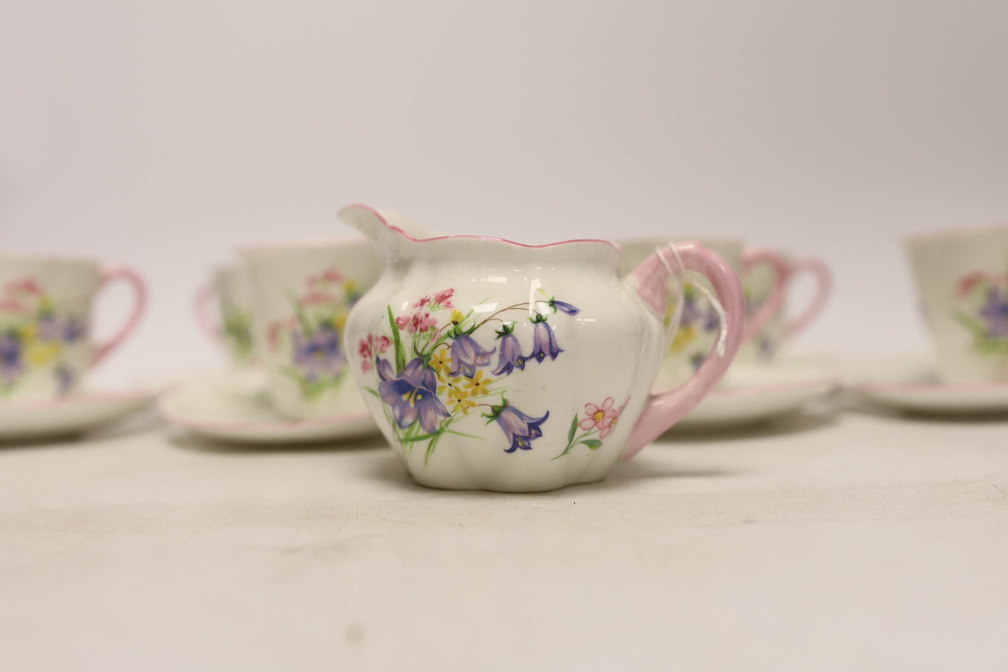 A Shelley 'wild flowers' bone china part tea set comprising milk jug and six cups and saucers